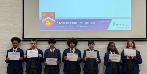 Line of stuednts holding up their certificates